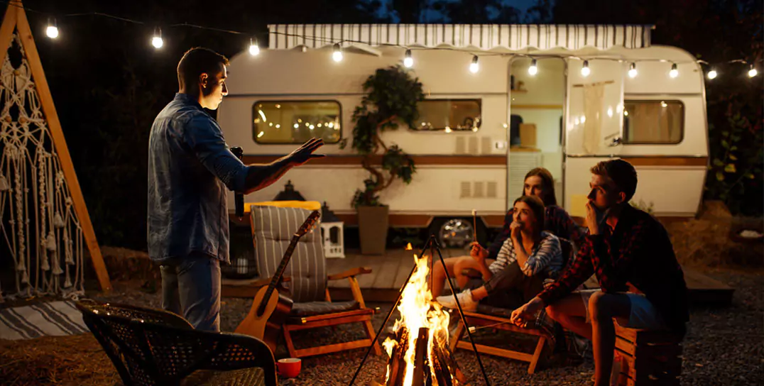 people gathering around bonfire