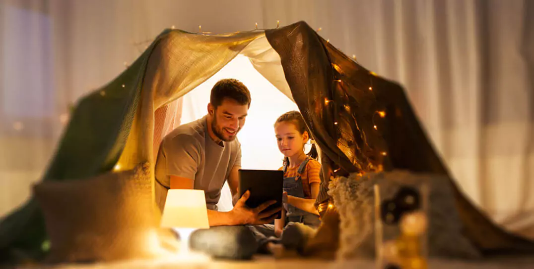 father and kid in a tent